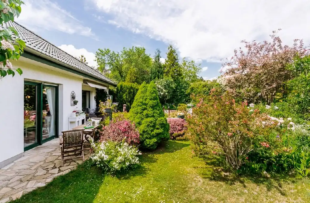 Gartenseite des Bungalows mit Natursteinterrasse in Rauen bei Fürstenwalde