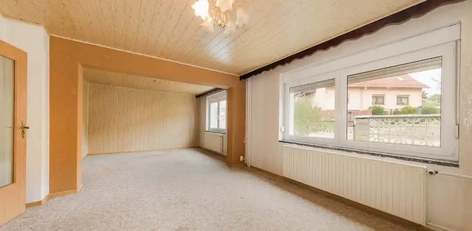 Zimmer mit Holzdecke und breitem Fenster im Haus in Neuzelle