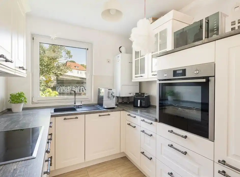 Helle Einbauküche mit Fenster im Bungalow in Rüdersdorf bei Berlin